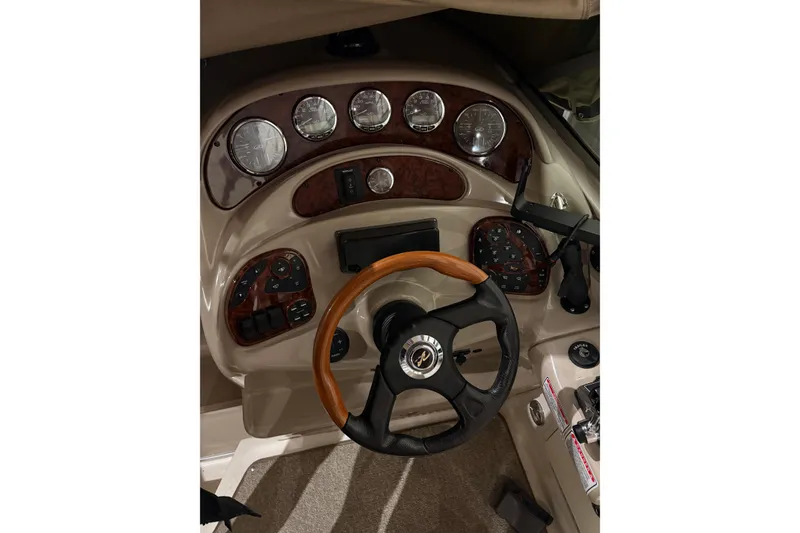 Slide: The Image of Dashboard of a 2004 Searay 280 Sundancer boat with wood accents and gauges. - 6