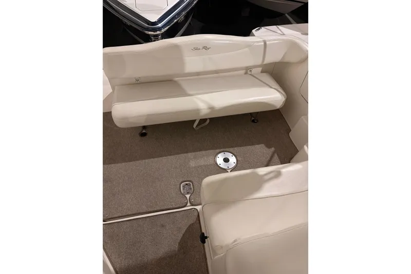 Slide: The Image of 2004 Searay 280 Sundancer interior seating with beige upholstery and carpeted flooring. - 9