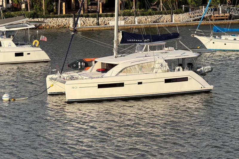 The Image of 2020 Leopard 40 catamaran anchored in a marina, surrounded by other boats. - 0