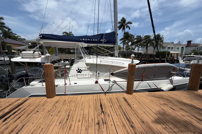 Slide: The Image of 2020 Leopard 40 catamaran docked, featuring sleek design and spacious deck. - 10