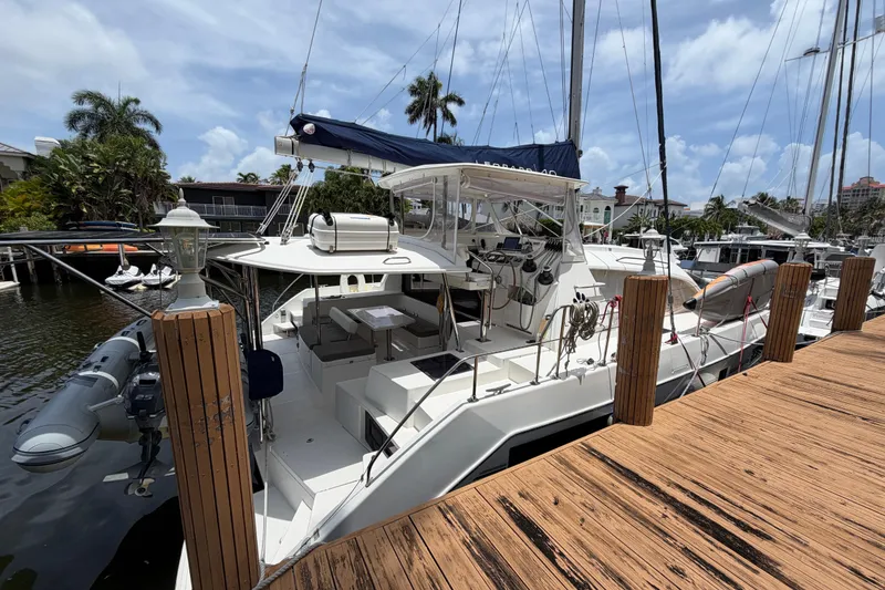 Slide: The Image of 2020 Leopard 40 catamaran docked at marina, featuring spacious deck and modern design. - 11