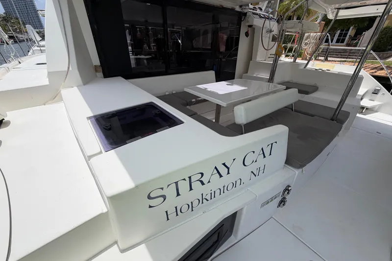 Slide: The Image of 2020 Leopard 40 catamaran "Stray Cat" docked, featuring outdoor seating and table. - 18