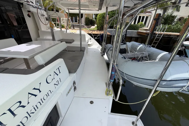 Slide: The Image of Leopard 40 catamaran, 2020 model, docked with inflatable dinghy and outdoor seating area. - 19