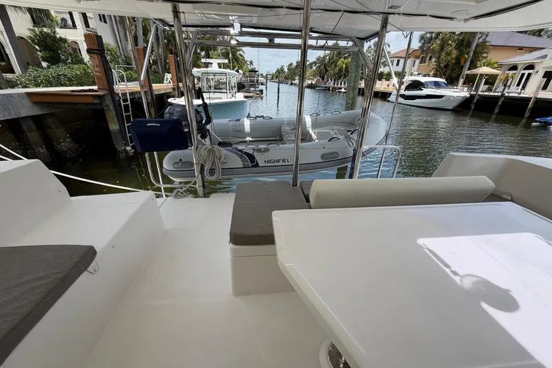 Slide: The Image of Leopard 40 catamaran deck with seating, docked near waterfront homes, 2020 model. - 24