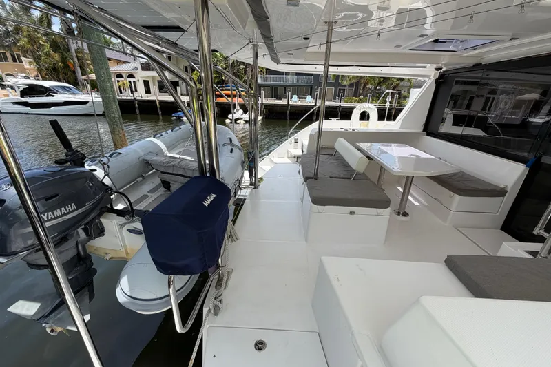 Slide: The Image of 2020 Leopard 40 yacht deck with seating, table, and Yamaha outboard motor. - 25