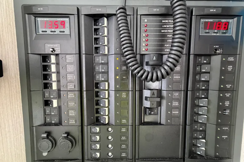 Slide: The Image of Electrical control panel on a 2020 Leopard 40 yacht, featuring various switches and displays. - 54