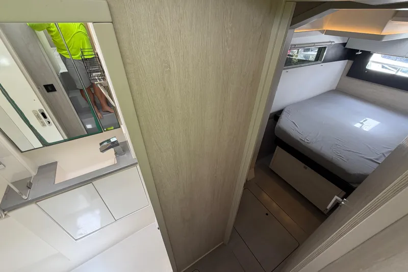 Slide: The Image of Interior of a 2020 Leopard 40 yacht showing a compact bedroom and bathroom. - 55