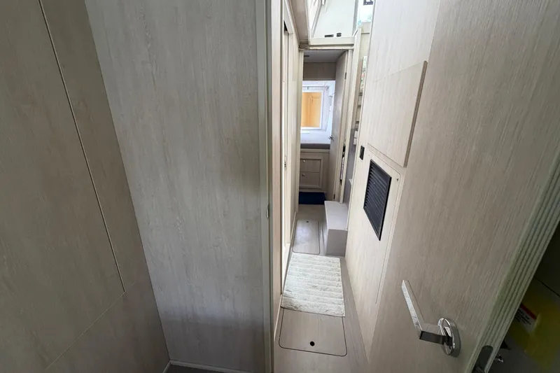 Slide: The Image of Interior hallway of a 2020 Leopard 40 catamaran, featuring light wood paneling. - 56