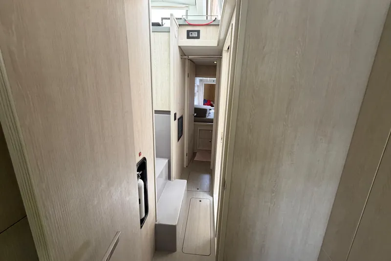 Slide: The Image of Interior hallway of 2020 Leopard 40 catamaran, featuring light wood paneling and compact design. - 59