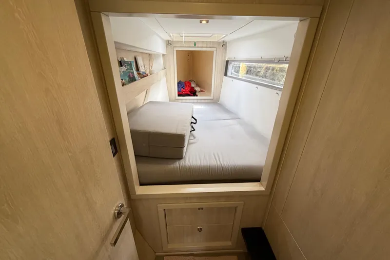 Slide: The Image of Interior cabin of a 2020 Leopard 40 yacht, featuring a cozy bed and window. - 62