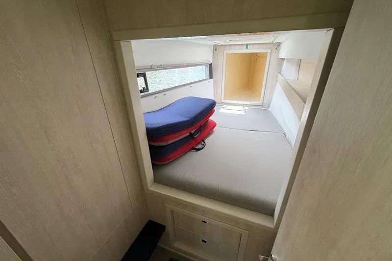 Slide: The Image of Interior cabin of a 2020 Leopard 40 catamaran with stacked cushions. - 65