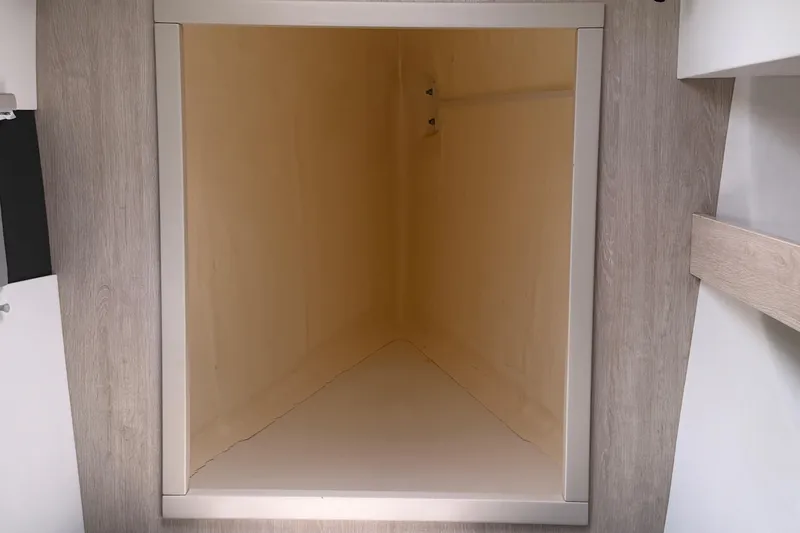 Slide: The Image of Empty storage compartment in a 2020 Leopard 40 catamaran interior. - 66