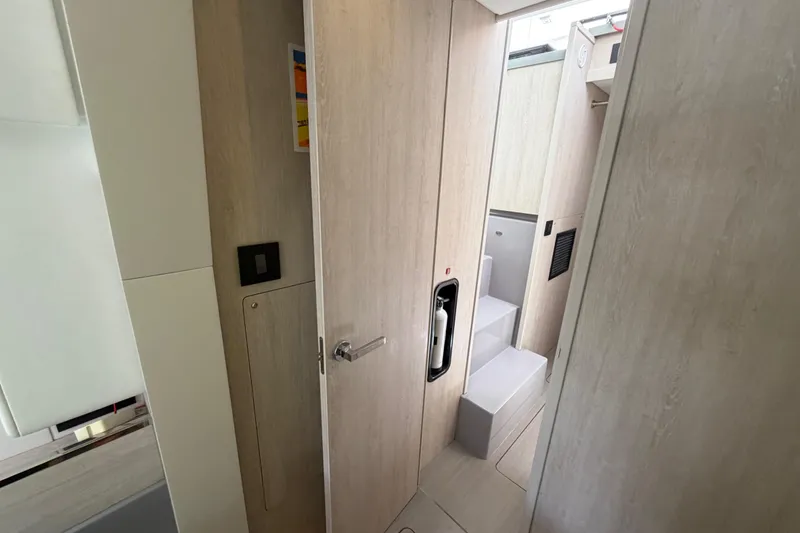 Slide: The Image of Interior of a 2020 Leopard 40 yacht, featuring modern wooden paneling and compact design. - 68