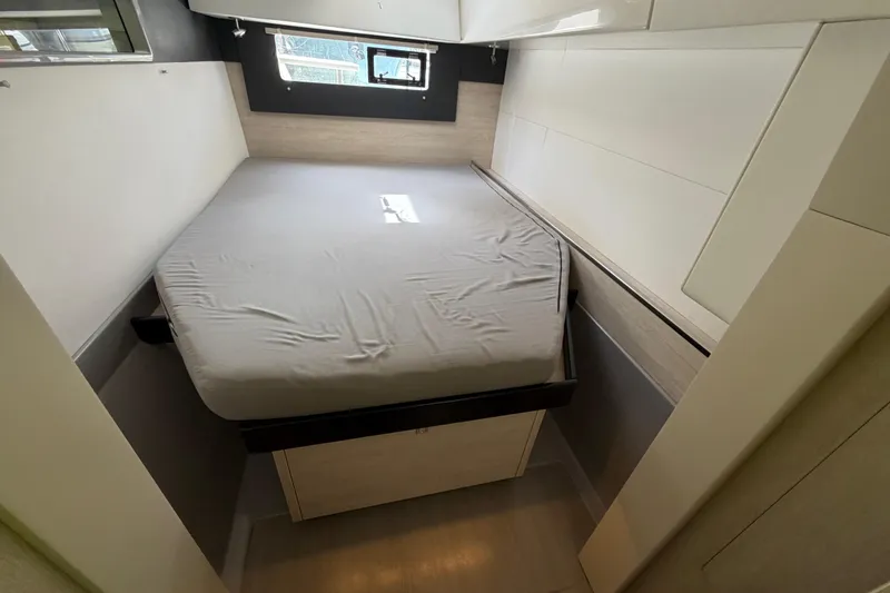 Slide: The Image of Compact bedroom interior in a 2020 Leopard 40 catamaran, featuring a neatly made bed. - 69