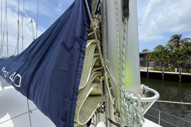Slide: The Image of Close-up of a 2020 Leopard 40 sailboat mast and rigging, docked near palm trees. - 72