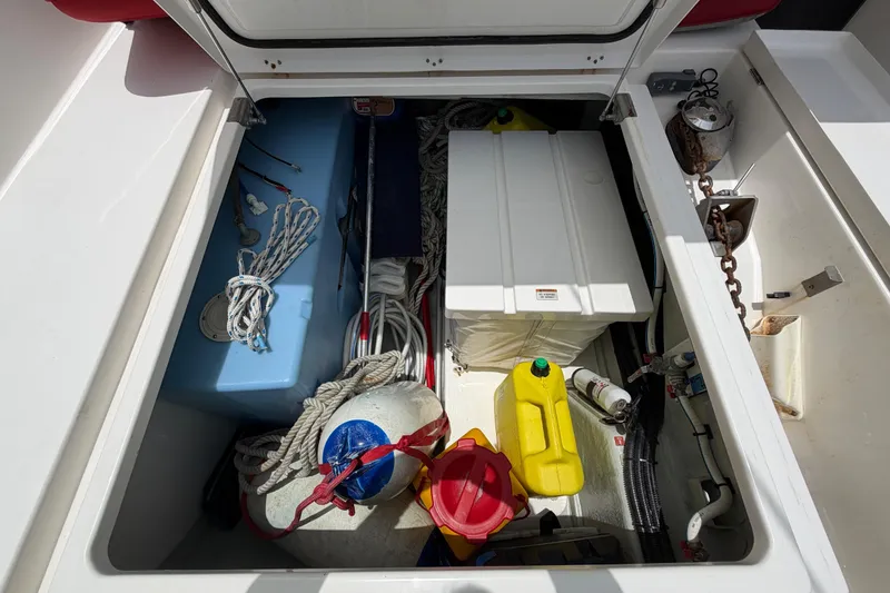 Slide: The Image of Storage compartment of a 2020 Leopard 40 boat with ropes, containers, and equipment. - 78