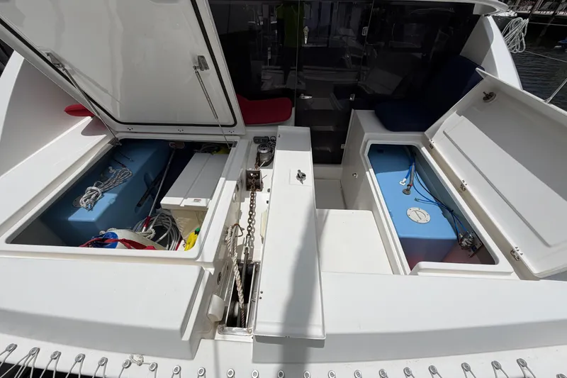Slide: The Image of Leopard 40 catamaran storage compartments open, showcasing interior equipment and ropes. - 79