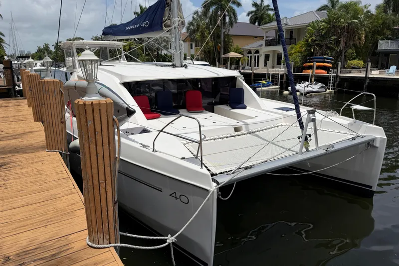 Slide: The Image of 2020 Leopard 40 catamaran docked, featuring spacious deck and modern design. - 8