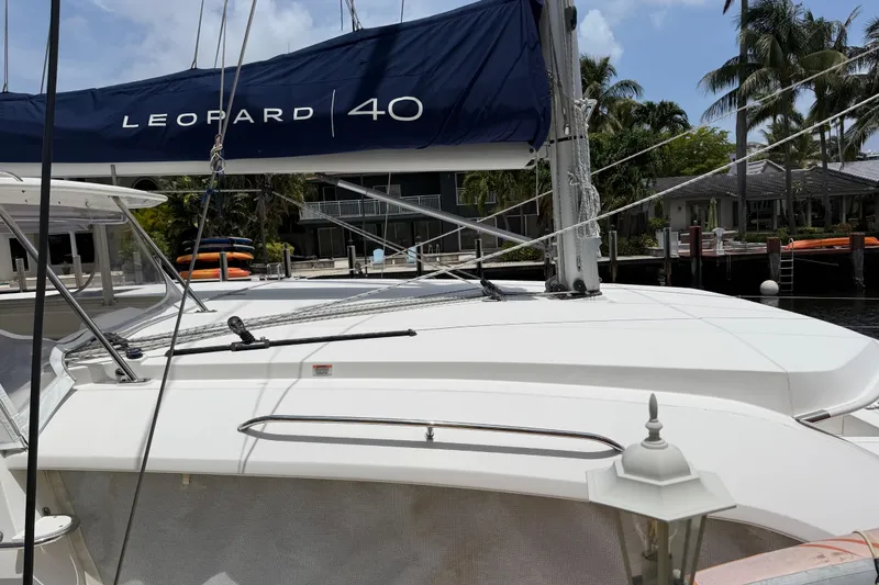 Slide: The Image of 2020 Leopard 40 catamaran docked, featuring sleek design and visible sail rigging. - 83