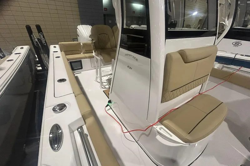 Slide: The Image of 2026 Sportsman Heritage 231 Center Console boat interior with beige seating and modern design. - 3
