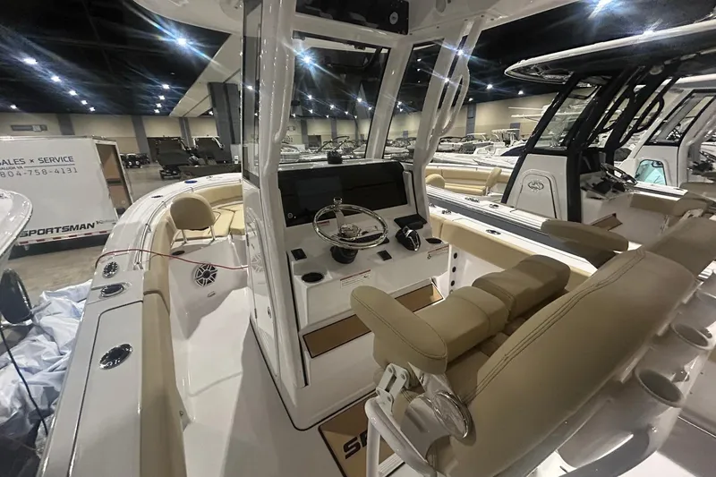 Slide: The Image of 2026 Sportsman Heritage 231 Center Console boat interior at a showroom display. - 7