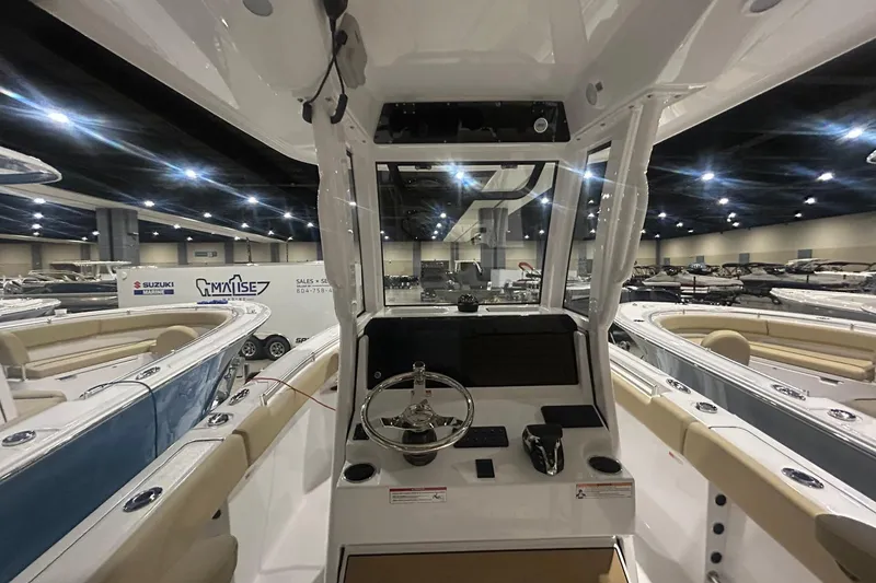 Slide: The Image of 2026 Sportsman Heritage 231 Center Console boat interior at a showroom display. - 8
