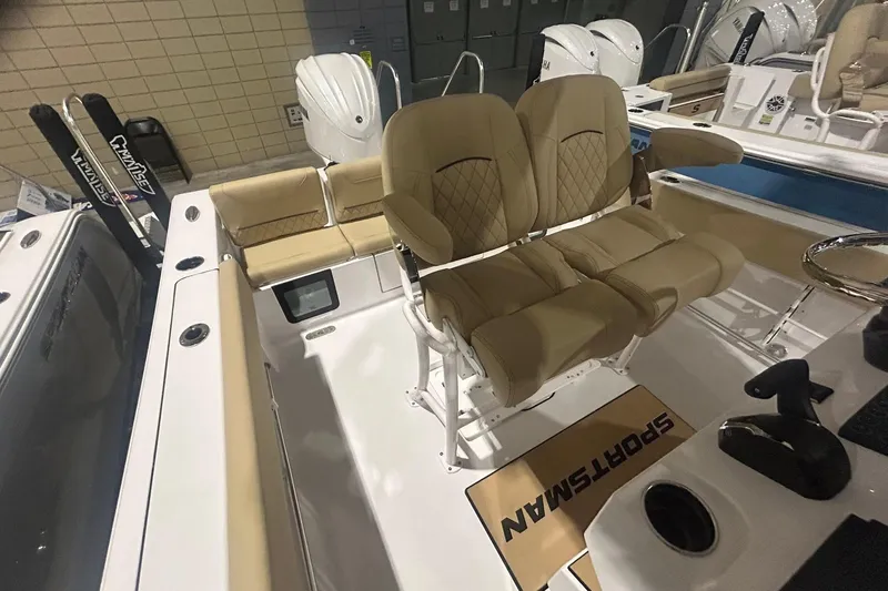 Slide: The Image of 2026 Sportsman Heritage 231 Center Console boat interior with tan seating and modern design. - 9