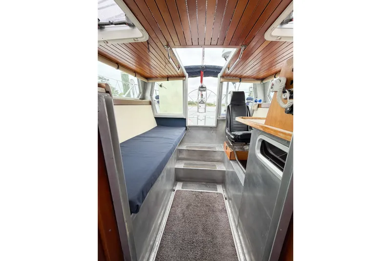 Slide: The Image of Interior of 1998 Limited Edition Hike Metal boat, featuring wood paneling and seating. - 14