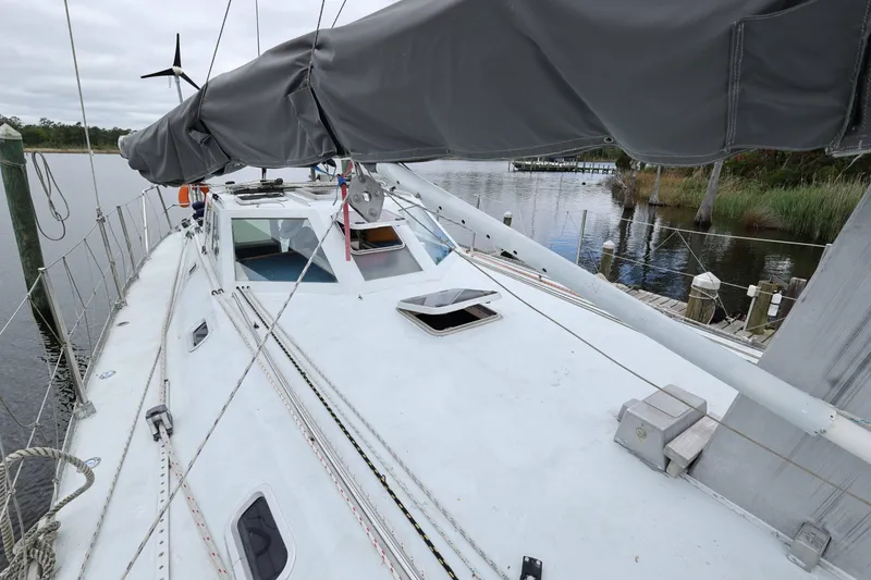 Slide: The Image of Limited Edition 1998 Hike Metal sailboat docked by a serene riverside. - 18