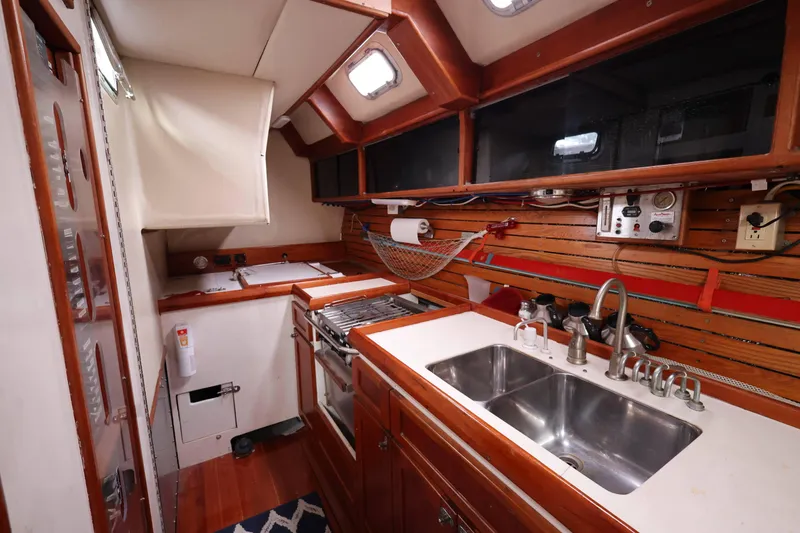Slide: The Image of 1998 Limited Edition Hike Metal yacht kitchen with dual sinks and wooden cabinetry. - 6