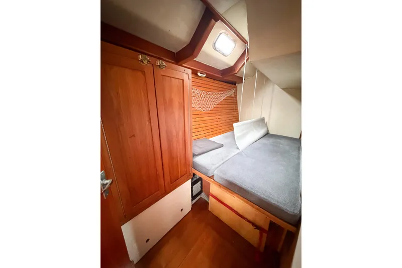 Slide: The Image of Cozy cabin interior of 1998 Limited Edition Hike Metal boat with wooden accents and bedding. - 7