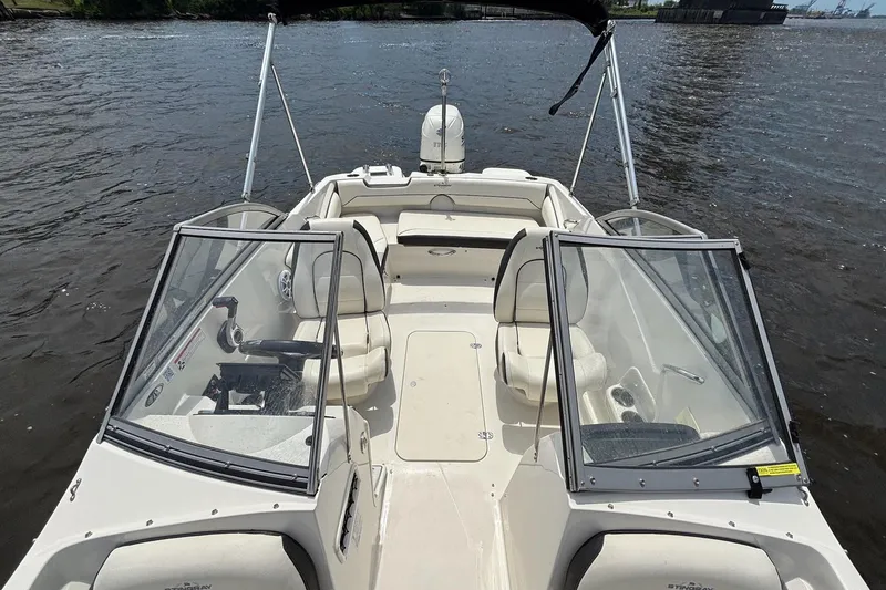 Slide: The Image of 2020 Stingray 191 DC boat with open seating on a calm waterway. - 10