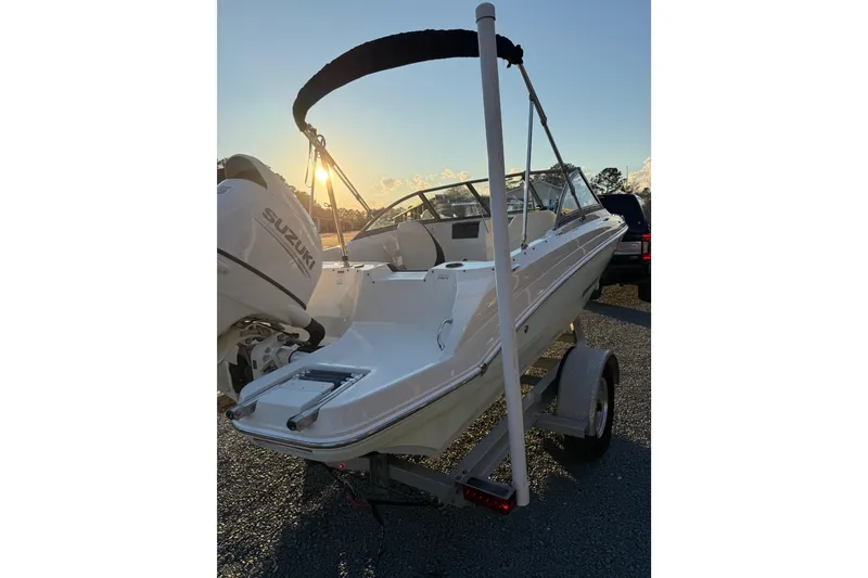 Slide: The Image of 2020 Stingray 191 DC boat on trailer at sunset with Suzuki engine. - 4