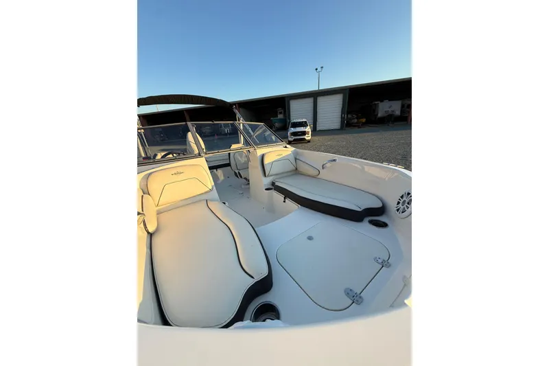 Slide: The Image of 2020 Stingray 191 DC boat interior with white seating and open storage compartments. - 6