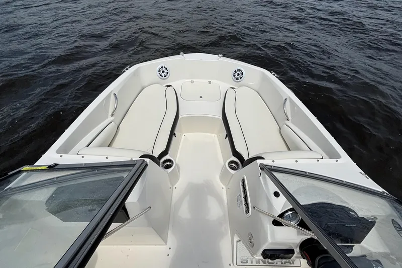 Slide: The Image of 2020 Stingray 191 DC boat interior with white seating and open water view. - 9