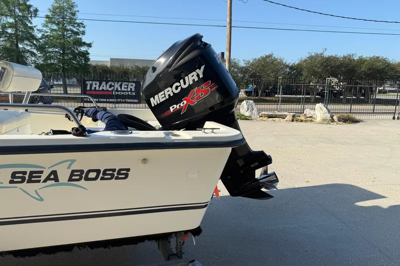 Slide: The Image of 2006 Sea Boss 21 Bay Boat with Mercury Pro XS engine, parked outdoors. - 6