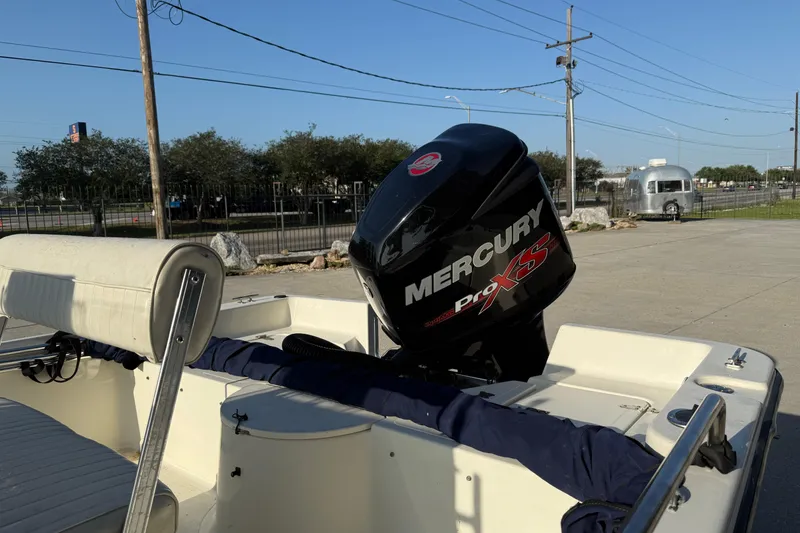 Slide: The Image of 2006 Sea Boss 21 Bay Boat with Mercury Pro XS engine in a parking area. - 8