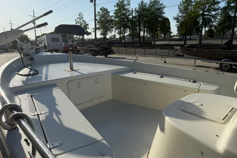 Slide: The Image of 2006 Sea Boss 21 Bay Boat interior with seating and storage, parked outdoors. - 9