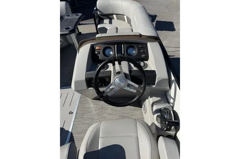 Slide: The Image of 2023 Bennington 23 SX boat interior with steering wheel and dashboard controls. - 9