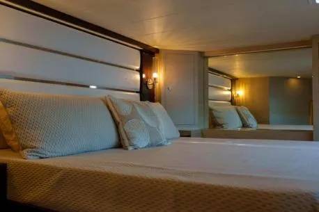 Slide: The Image of Luxurious bedroom interior in 2022 Horizon PC65 yacht, featuring elegant lighting and cozy bedding. - 102