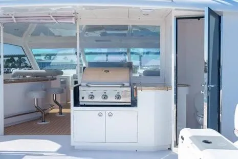 Slide: The Image of Luxury yacht Horizon PC65 2022 with outdoor grill and seating area. - 18