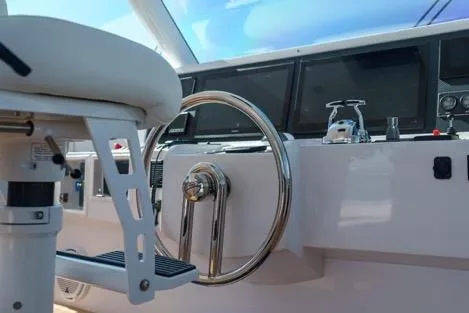 Slide: The Image of Helm of 2022 Horizon PC65 yacht with steering wheel and navigation screens. - 19