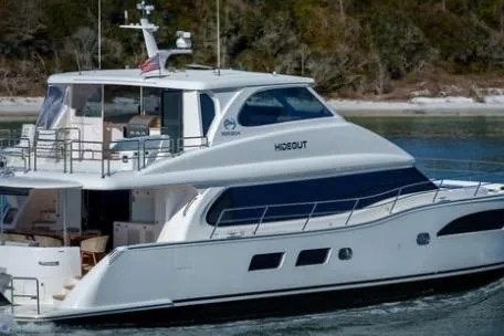 Slide: The Image of 2022 Horizon PC65 yacht cruising on water, featuring sleek design and modern amenities. - 2