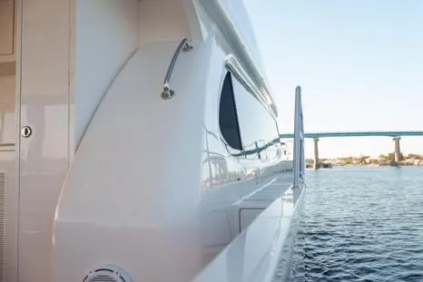 Slide: The Image of 2022 Horizon PC65 yacht side view with bridge and water in the background. - 20