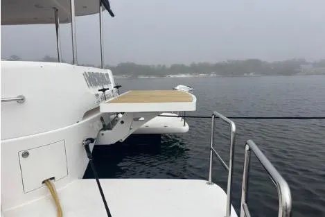 Slide: The Image of 2022 Horizon PC65 yacht docked on a foggy lake. - 25