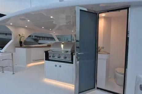 Slide: The Image of Luxurious 2022 Horizon PC65 yacht with outdoor kitchen and modern bathroom. - 33
