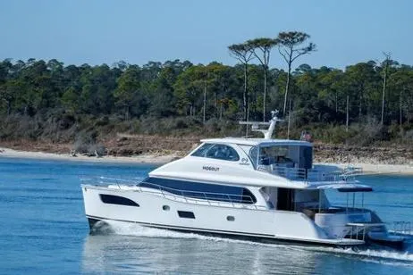 Slide: The Image of 2022 Horizon PC65 yacht cruising near a forested shoreline. - 4