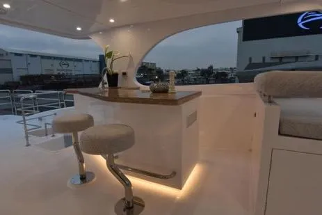 Slide: The Image of Luxurious Horizon PC65 yacht interior with elegant bar stools and ambient lighting, 2022 model. - 42