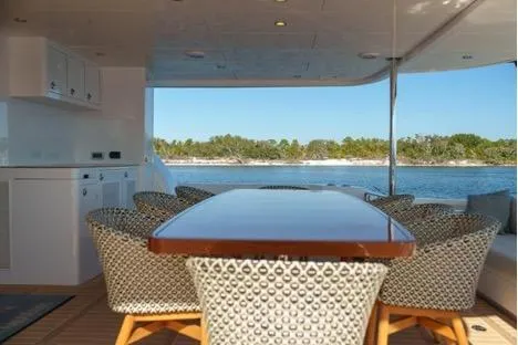 Slide: The Image of Luxury yacht Horizon PC65 2022 with elegant dining area overlooking serene waters. - 47