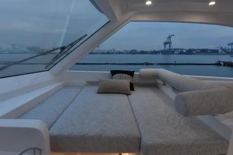 Slide: The Image of Luxurious interior of 2022 Horizon PC65 yacht with waterfront view at dusk. - 49